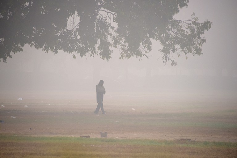Man walks in heavy smog