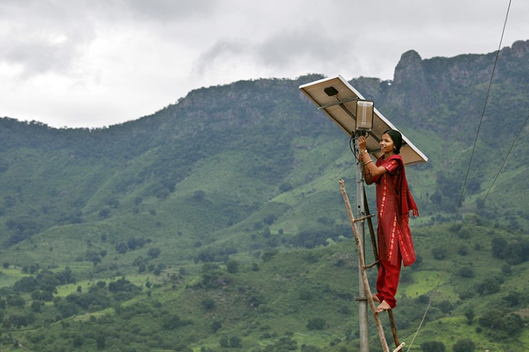Person working on solar panel in India