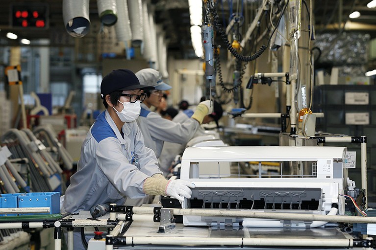 Workers assemble indoor units of Daikin Industries Ltd. split type air conditioners.