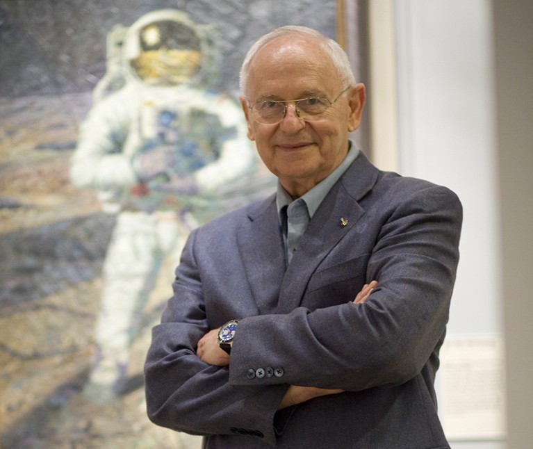 A photograph of Alan Bean in front of one of his paintings in the National Air and Space Museum in the USA, 2009.