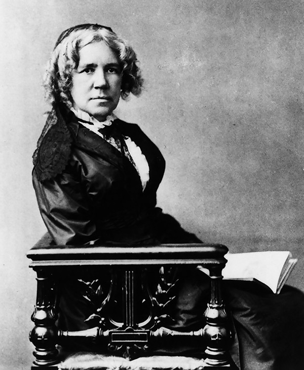 Undated portrait photograph of Maria Mitchell, seated, holding an open book.