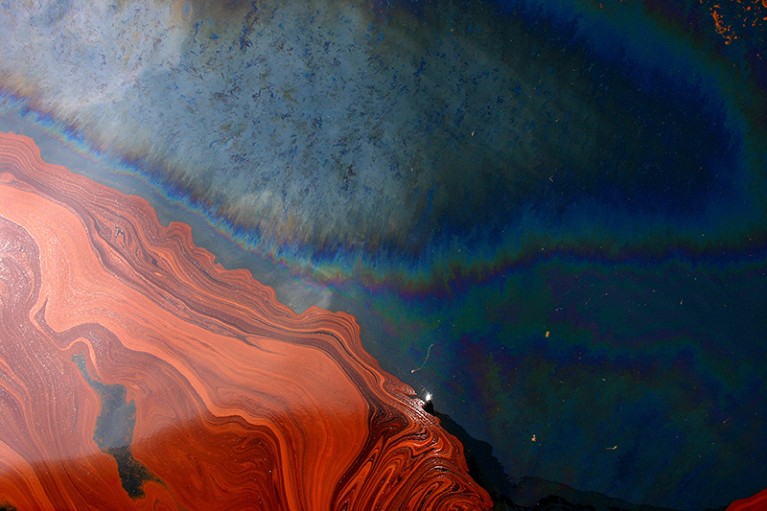 Close up of rust coloured oil and sheen floating atop water in the Gulf of Mexico on June 17th 2010.