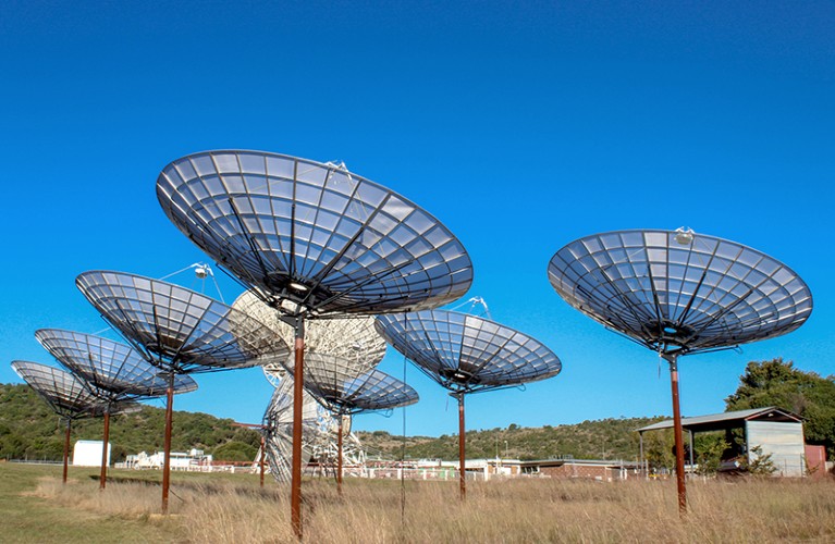 The first few HIRAX dishes in South Africa, with their neighbour the VLBI dish in the background.