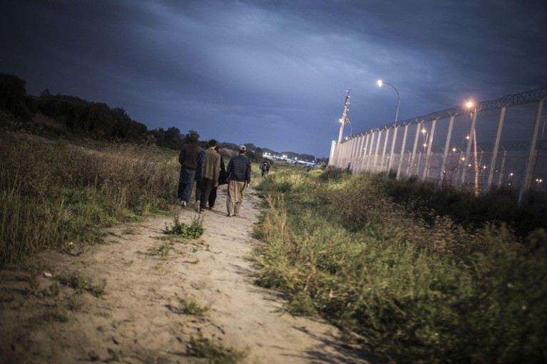 A group of young men walking to the "Jungle" camp in Calais