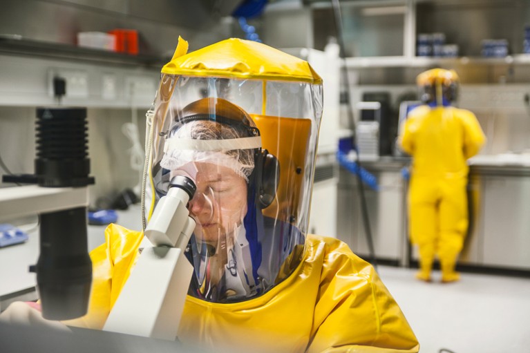 Staff in high security laboratory wear protective clothing