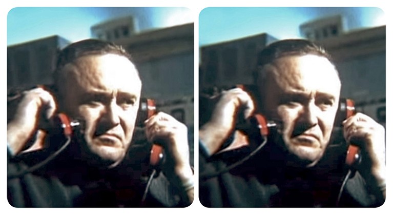 Stereoscopic view of Sergei Korolev holding up a phone to each ear.