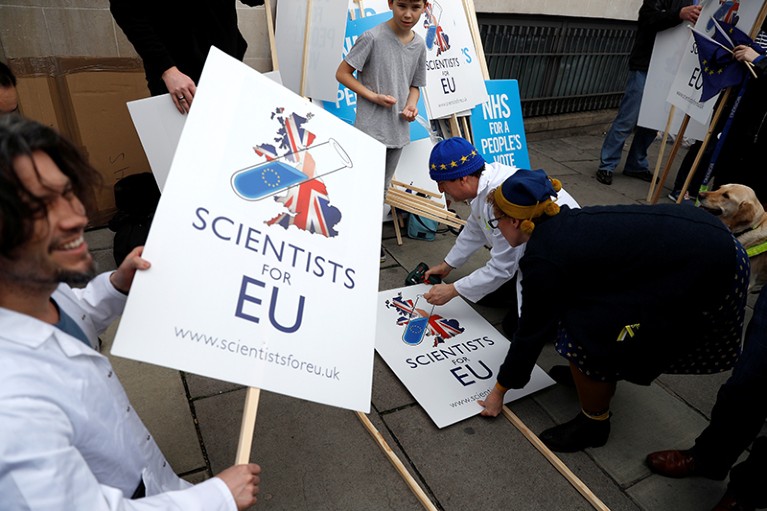 EU supporters hold signs saying 'Scientist for EU' as they prepare to participate in the 'People's Vote' march in central London