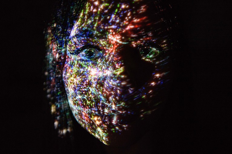 A virtual map of the internet is projected onto a human face