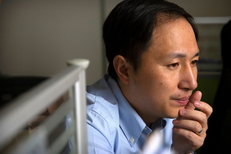 He Jiankui looks at a computer screen while working at a lab in Shenzhen