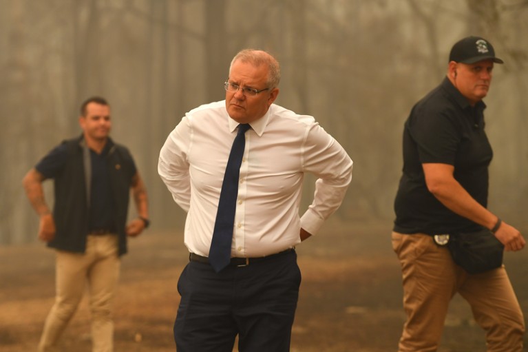 Australian Prime Minister Scott Morrison observes the damage caused by bushfires in Sarsfield, Victoria, Australia