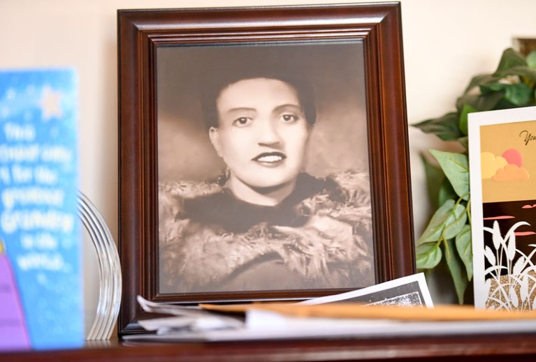 A framed photo of Henrietta Lacks sits in a living room