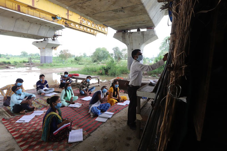 A university student conducts open-air classes in a slum for underprivileged students