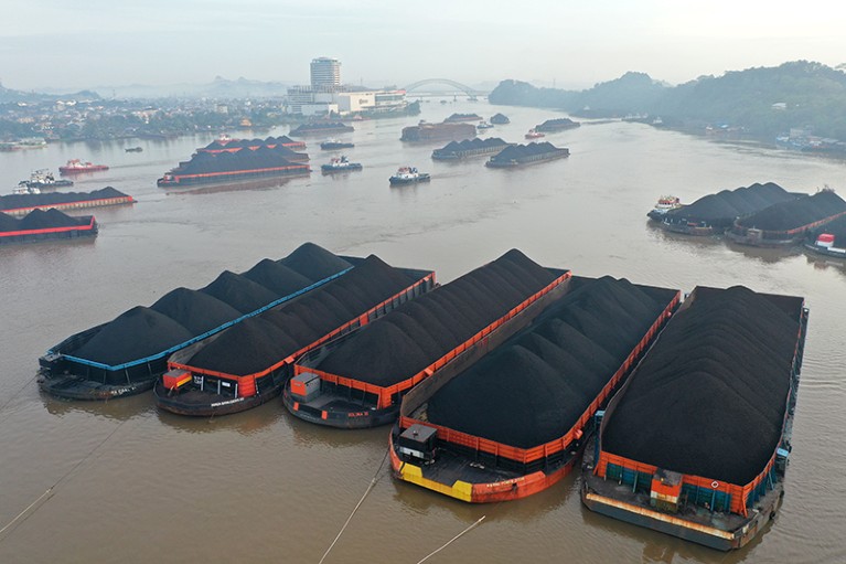 Barges transporting coal are moored on the Mahakam River in Samarinda, East Kalimantan, Indonesia