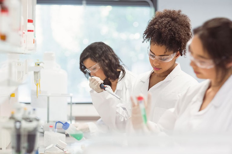 Three science students working in a laboratory