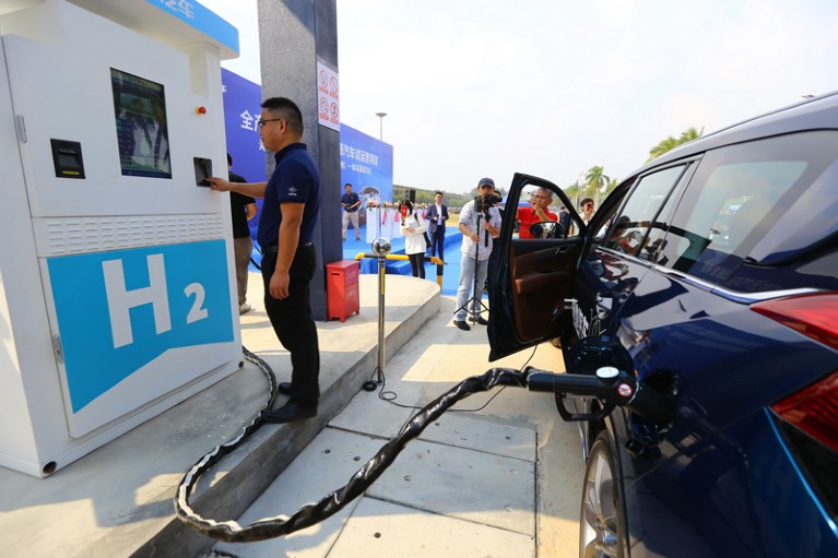 A man charges a hydrogen fuel cell car at Haima Automobile's first hydrogen refuelling station