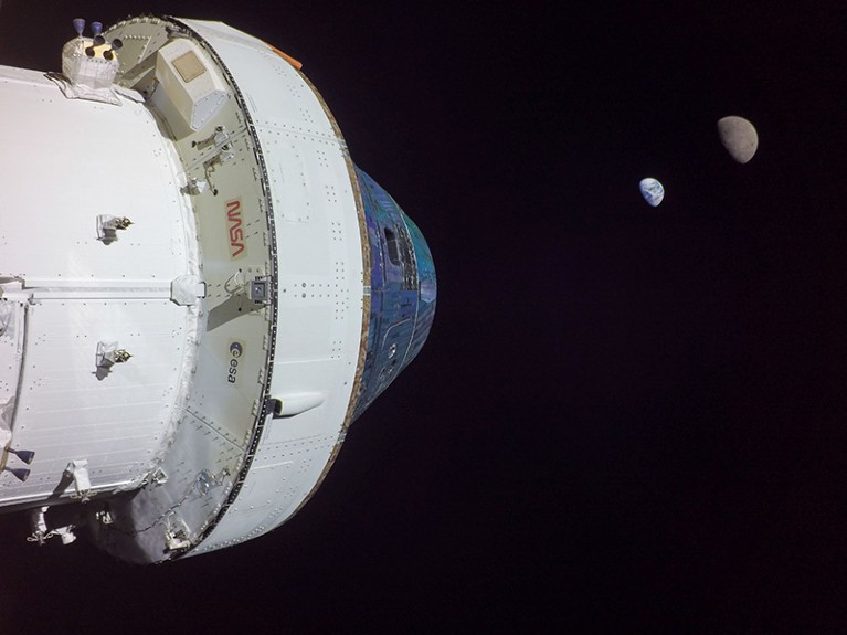 Orion at its maximum distance from Earth during the Artemis I mission, with the Earth and moon in the background in space.