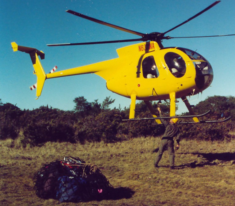 Jim near an helicopter, loading flying gear in preparation for the Po’ouli translocation operation.