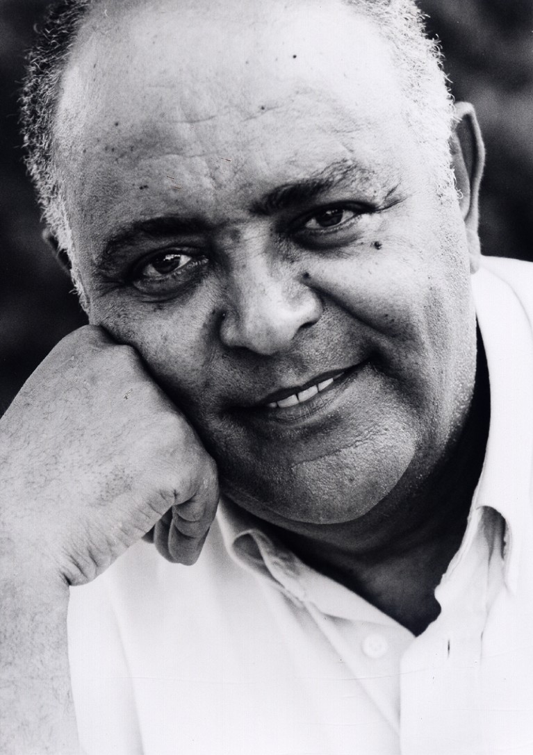 A black and white image of Melaku Worede taken in 1989