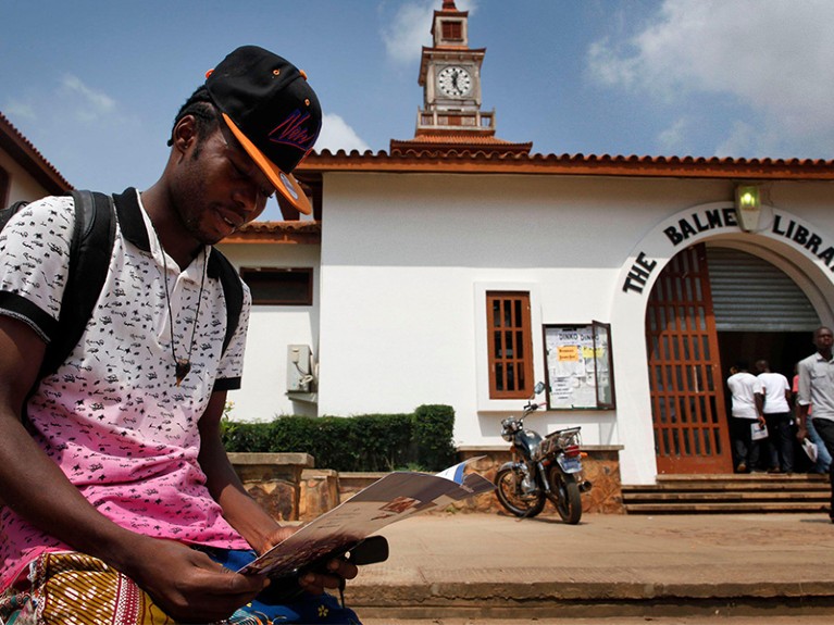 Student Josaih Amezado sits in front of Balme Library at the University of Ghana in Accra, Ghana.
