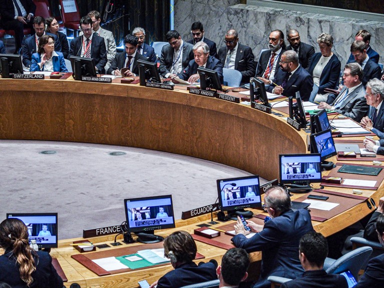 Antonio Guterres sits with world leaders around a circular table at a UN security council meeting on AI in warfare