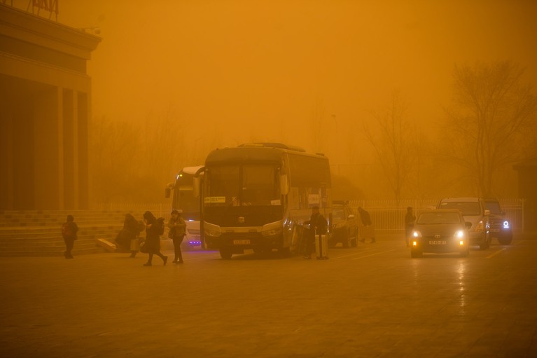 Cars move amid thick sand and dust on March 27, 2024 in Erenhot, Inner Mongolia Autonomous Region of China.