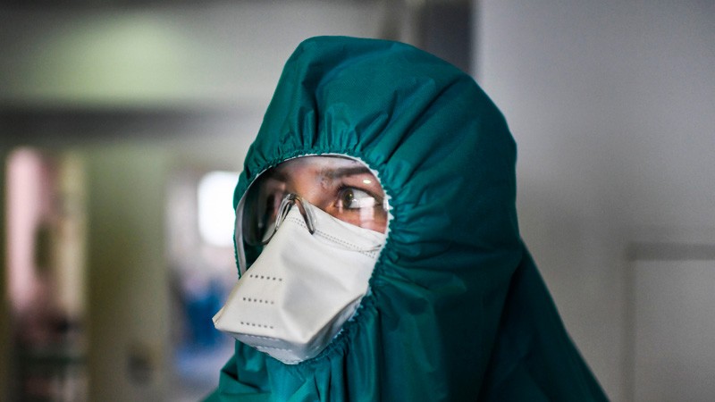 A health worker wearing a protective suit prepares before entering the ICU of COVID-19 in Lisbon.