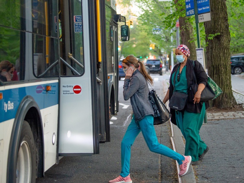 NYC Medical workers wearing masks board an MTA bus amid the coronavirus pandemic.