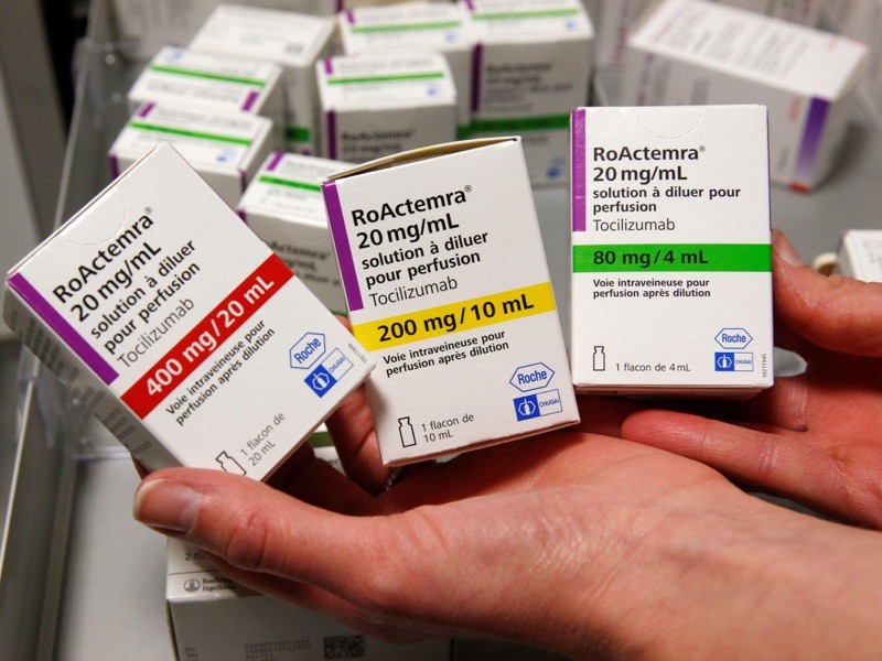 A pharmacist displays boxes of tocilizumab.