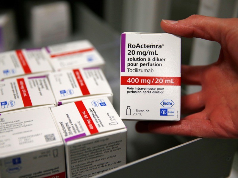 A pharmacist displays a box of tocilizumab, which is used in the treatment of rheumatoid arthritis, France.