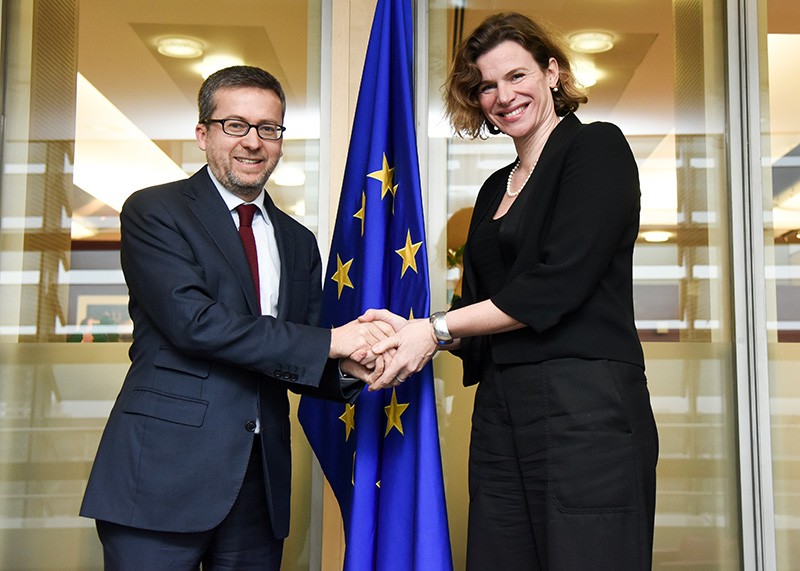 Carlos Moedas, left, shaking hands with Mariana Mazzucato at the European Commission
