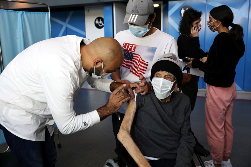 An elderly man receives a vaccination against COVID-19 in a vaccination centre in Israel