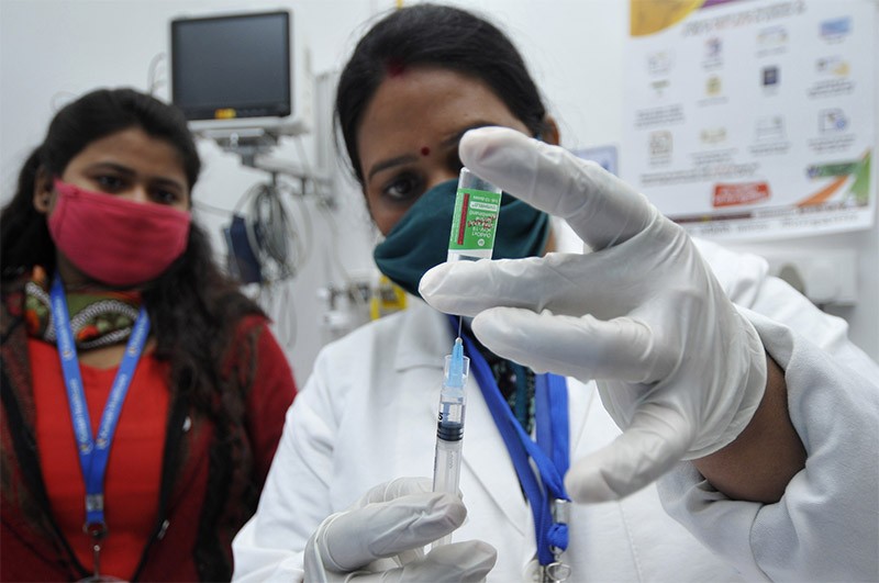 Photo of a health worker preparing a Covishield vaccine dose at a private hospital in Noida, India