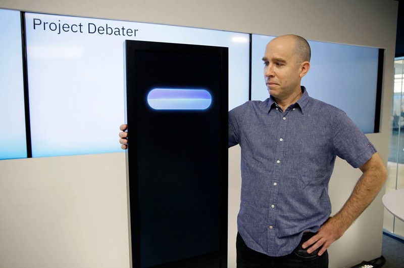 Noam Slonim stands with the IBM Project Debater