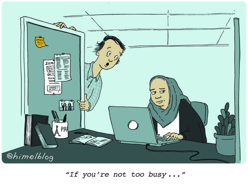 Cartoon: One person leans into another's office cubicle. Caption: 
