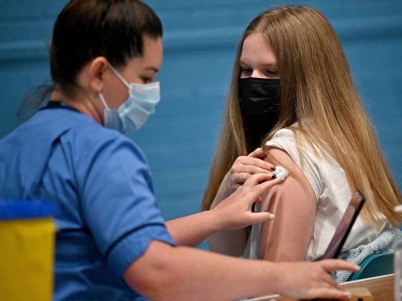 A teenager Eve Thomson receives a COVID-19 vaccine at a vaccination centre in Barrhead, UK..