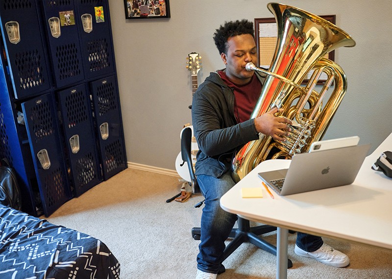 A person plays a brass instrument at Huston-Tillotson University as part of the African American Male Teacher Initiative.