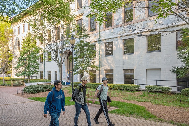 Three college students walking on the Emory University campus in Atlanta, Georgia, US.