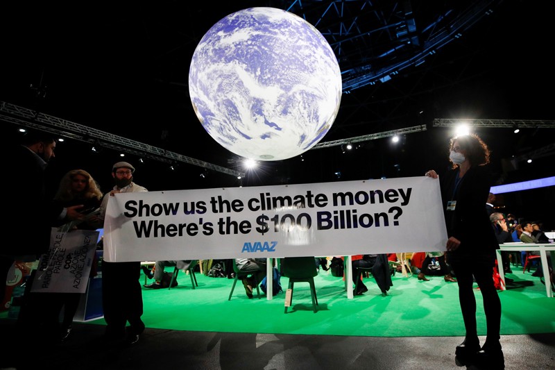 Avaaz activists hold a sign during the UN Climate Change Conference