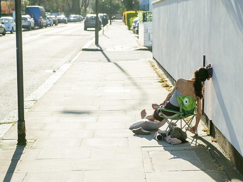 A members of the public seen sunbathing in the street around the corner from Primrose Hill on April 5, 2020 in London, England.