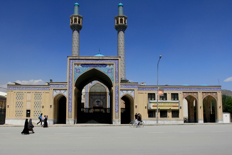 People walk in front of the Khatam-al-Nabyeen university and Shiite mosque in Kabul