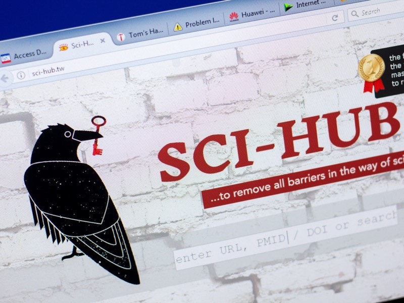 Sci Hub website on the PC display.