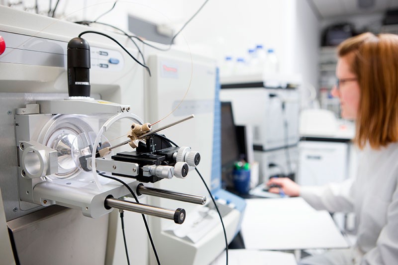 Researcher using a mass spectrometer to analyse proteins at the University of Dundee, Scotland.