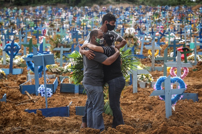 Relatives of a deceased person mourn during a mass burial of COVID-19 victims at the Parque Taruma cemetery in Manaus, Brazil.
