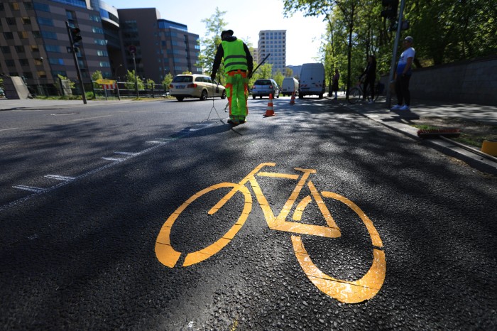 A painted yellow bicycle symbol sits in the centre of a new bike lane