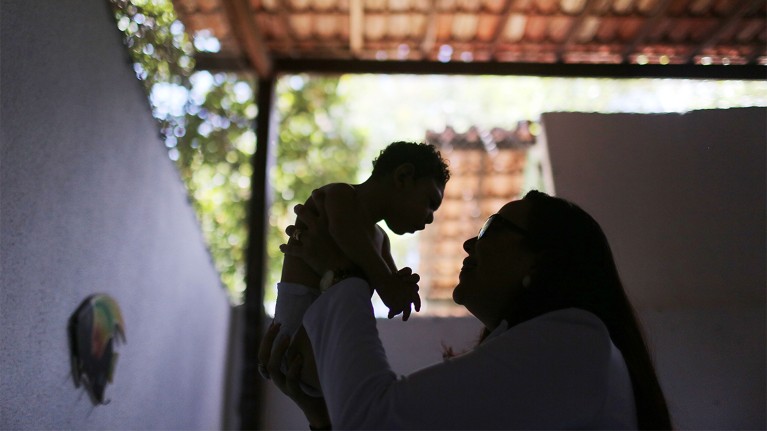 A physician in Brazil examines a baby with microcephaly, which can be caused by infection with Zika virus before birth.