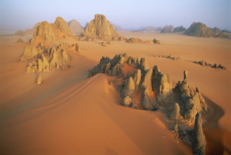 Pinnacles of sandstone rise through the orange dunes of the Karnasai Valley, a few kilometers from Chad's border with Libya.