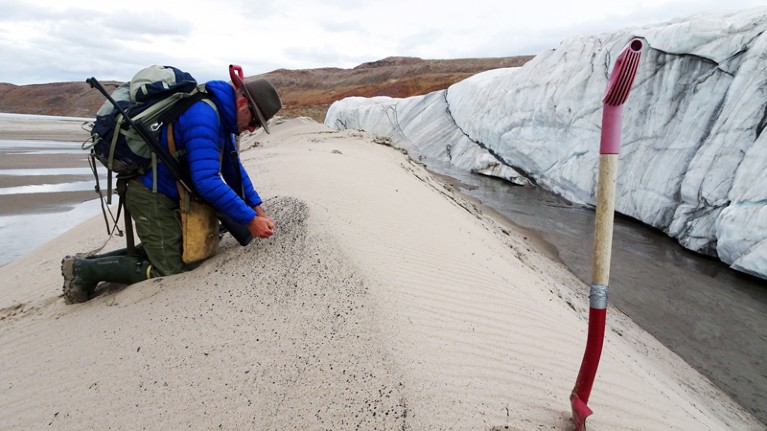collecting sand samples at the front of Hiawatha Glacier