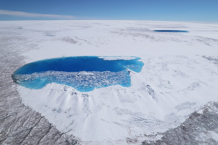 Aerial view of a melt pool and contrasting colours of the Greenland Ice Sheet
