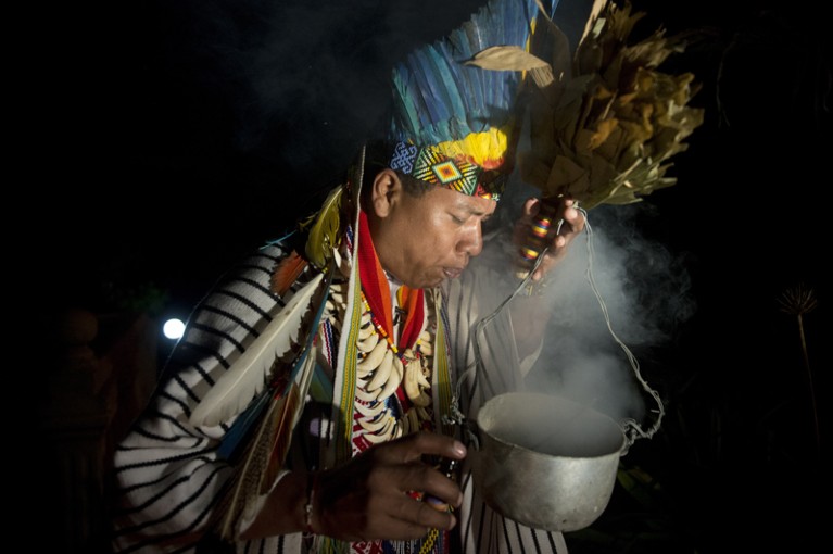 A healer with a hallucinogenic mixture during a traditional ceremony in Colombia