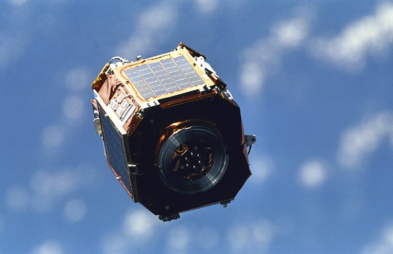 SAC-A satellite in orbit above the Earth.